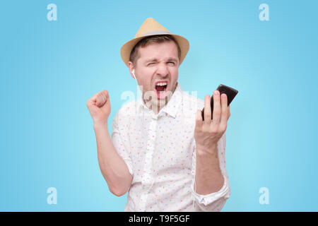 Happy young man in summer hat with headphones. Stock Photo