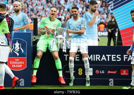 London, England 18th May Manchester City goalkeeper Ederson Moraes and Riyad Mahrez hold the trophy after winning the FA Cup Final between Manchester City and Watford at Wembley Stadium, London on Saturday 18th May 2019. (Credit: Jon Bromley | MI News) Credit: MI News & Sport /Alamy Live News Stock Photo