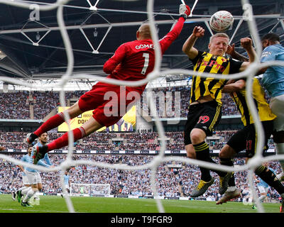 London, UK. 18th May, 2019. Watford's Heurelho Gomes (1st L) and Watford's Will Hughes (2nd L) try to save the ball during the English FA Cup Final between Manchester City and Watford at Wembley Stadium in London, Britain on May 18, 2019. Manchester City won 6-0 and became the first English men's side to achieve the feat of winning the Premier League, FA Cup and Carabao Cup in the same season. Credit: Han Yan/Xinhua/Alamy Live News Stock Photo