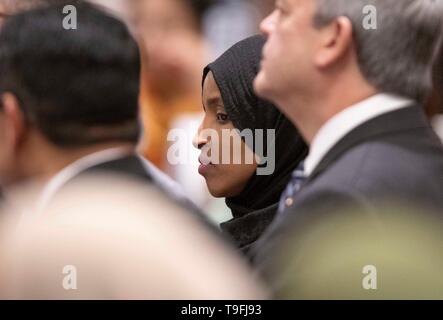 Congresswoman Ilhan Omar of Minnesota's 5th Congressional District listens to a speaker at the annual city-wide iftar dinner in Austin, Texas, in honor of the 14th day of Ramadan. Stock Photo