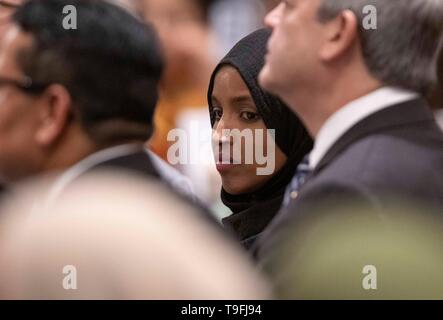 Congresswoman Ilhan Omar of Minnesota's 5th Congressional District listens to a speaker at the annual city-wide iftar dinner in Austin, Texas, in honor of the 14th day of Ramadan. Stock Photo