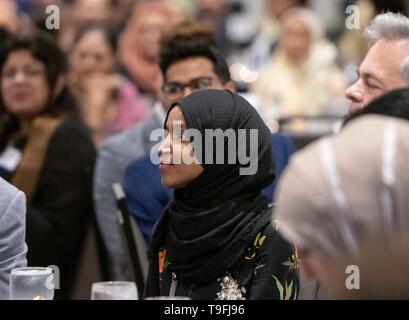 Congresswoman Ilhan Omar of Minnesota's 5th Congressional District listens to a speaker at the annual city-wide iftar dinner in Austin, Texas, in honor of the 14th day of Ramadan. Stock Photo