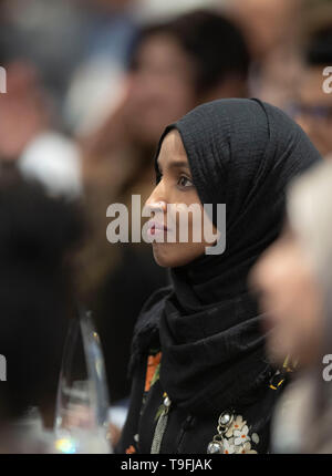 Congresswoman Ilhan Omar of Minnesota's 5th Congressional District listens to a speaker at the annual city-wide iftar dinner in Austin, Texas, in honor of the 14th day of Ramadan. Stock Photo