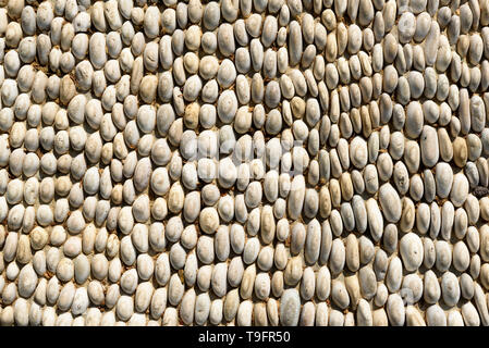 Pattern of round pebble stone. Background of the river rock pebbles (selected focus) Stock Photo