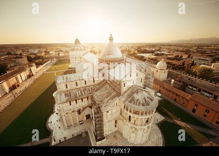 Cathedral viewed from top of Pisa leaning tower at sunset wide angle view Stock Photo