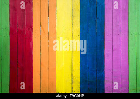 Full frame textured background of gay pride rainbow colors painted on slats of weathered wood Stock Photo