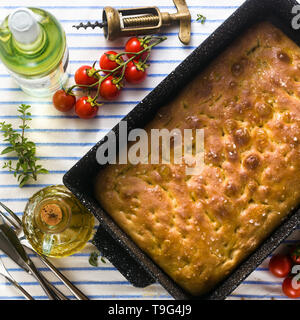 Italian focaccia and grilled vegetables on a table with red wine and aromatic herbs. summer menu Stock Photo