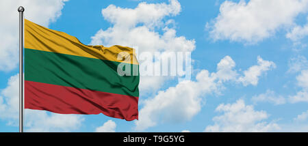 Lithuania flag waving in the wind against white cloudy blue sky. Diplomacy concept, international relations. Stock Photo