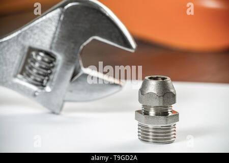 Plumbing pipeline element and adjustable wrench Stock Photo