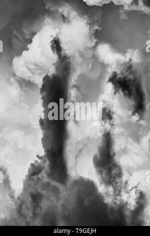 Abstrac shapes of air masses forming complex clouds during storm high in the sky as a fusion of dark and bright. Stock Photo