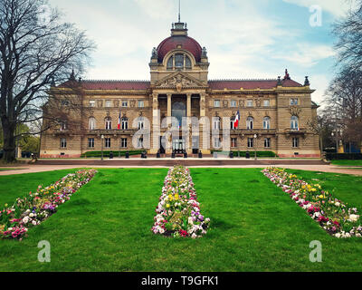 Green grass and flowers in front of Palais du Rhin. Strasbourg Republic Square (Place de la Republique). Prussian architecture Palace. Stock Photo