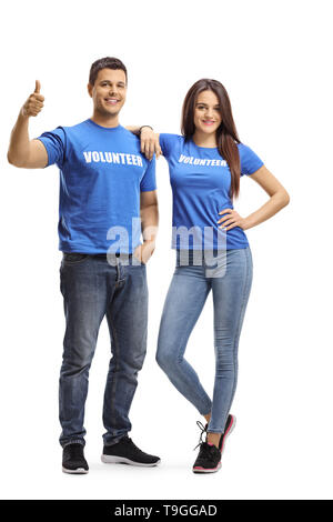 Full length portrait of young volunteers posing and showing thumbs up isolated on white background Stock Photo