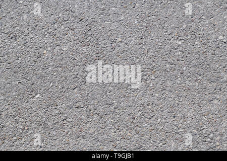 Asphalt background texture with some fine grain under the sun Stock Photo