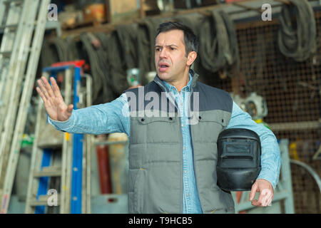 male worker making hand gesture to stop Stock Photo