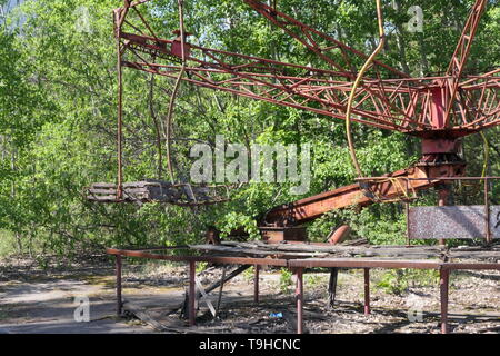 Abandoned carousel in the amusement park near the ghost town of Pripyat, Chernobyl exclusion zone, Ukraine Stock Photo