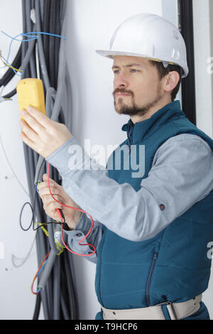 electrician sets cables Stock Photo
