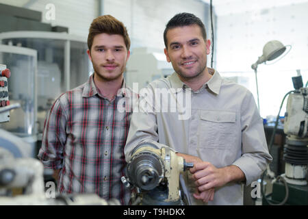 teacher and apprentice in a workshop Stock Photo