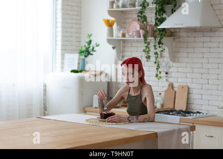 Red-haired woman looking miserable after suffering from anorexia Stock Photo