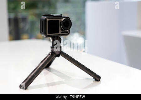 CHINA, SHANGHAI - MAY 18, 2019. DJI OSMO ACTION IN PROTECTED CASE AND TRIPOD. Stock Photo