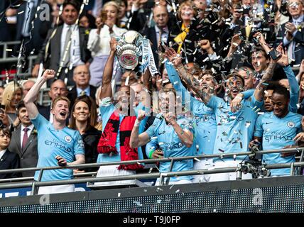 London, UK. 18th May, 2019. Captain Vincent Kompany of Manchester City lifts the FA Cup during the FA CUP FINAL match between Manchester City and Watford at Wembley Stadium, London, England on 18 May 2019. Photo by Andy Rowland. Credit: PRiME Media Images/Alamy Live News Stock Photo