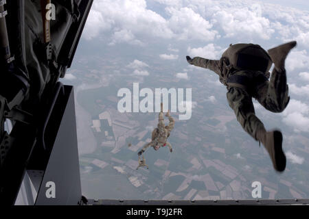 Avranches, France. 19th May, 2019. U.S. Army Airborne paratroopers with the 10th Special Forces Group, parachute out of a Air Force MC-130J Commando II aircraft, o commemorate the liberation of France in WWII May 18, 2019 in Avranches, France. Credit: Planetpix/Alamy Live News Stock Photo