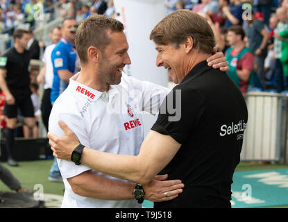 Magdeburg, Germany. 19th May, 2019. Soccer: 2nd Bundesliga, 1st FC Magdeburg - 1st FC Cologne, 34th matchday in the MDCC-Arena. Cologne coach Andre Pawlak (l) and Magdeburg coach Michael Oenning welcome each other before the game. Credit: Swen Pförtner/dpa - IMPORTANT NOTE: In accordance with the requirements of the DFL Deutsche Fußball Liga or the DFB Deutscher Fußball-Bund, it is prohibited to use or have used photographs taken in the stadium and/or the match in the form of sequence images and/or video-like photo sequences./dpa/Alamy Live News Stock Photo