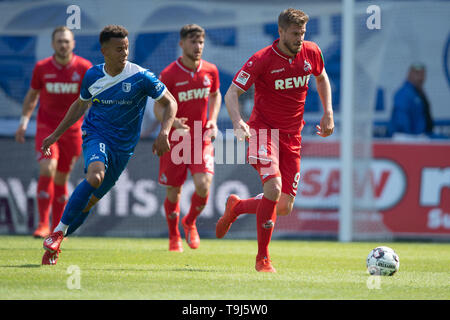 Magdeburg, Germany. 19th May, 2019. Soccer: 2nd Bundesliga, 1st FC Magdeburg - 1st FC Cologne, 34th matchday in the MDCC-Arena. Cologne's Simon Terodde (r) leads the ball against Magdeburg's Marcel Costly. Credit: Swen Pförtner/dpa - IMPORTANT NOTE: In accordance with the requirements of the DFL Deutsche Fußball Liga or the DFB Deutscher Fußball-Bund, it is prohibited to use or have used photographs taken in the stadium and/or the match in the form of sequence images and/or video-like photo sequences./dpa/Alamy Live News Stock Photo