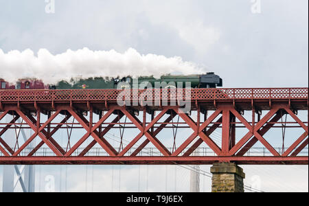 Forth Rail Bridge, North Queensferry, Fife, Scotland, United Kingdom, 19th May 2019. The Flying Scotsman steam train on tour around the Fife Circle, crossing the iconic bridge over the Firth of Forth, known simply as 'The Bridge' without needing an identification number like all other railway bridges. The steam train on its way towards Fife seen from North Queensferry Stock Photo