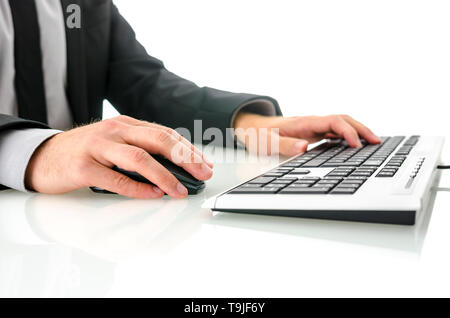 Side view of business man using office computer on white desk Stock Photo