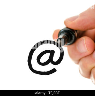 Close up of male hand writing an email symbol on a glass board. Over white background. Stock Photo