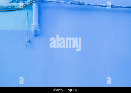 Bright blue colored wall of the building close-up Stock Photo