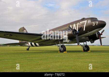 Second World War Douglas C-47 Skytrain transport plane in period camouflage markings - including D Day 'invasion stripes' . Whiskey seven callsign Stock Photo