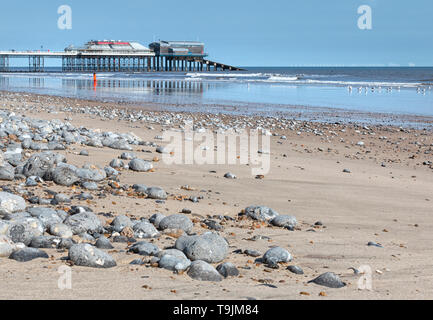 Low level viewpoint across Cromer Beach to the pier, North Norfolk, East Anglia. Stock Photo