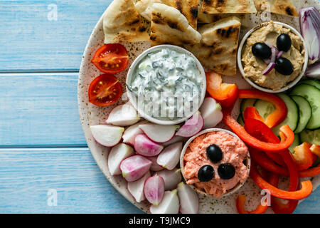 Selection of traditional greek food - salad, meze, pie, fish, tzatziki, dolma on wood background Stock Photo