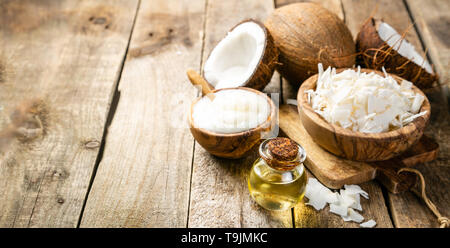 MCT coconut oil concept - coconuts, butter and oil on wood background Stock Photo