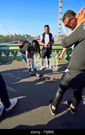 London, England, UK. Illegal Cup and Ball / 3 Cups Trick on Westminster Bridge, trying to con money from passing tourists on a Bank Holiday