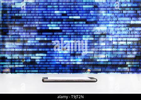 mobile phone sitting on glossy white table with  Blue binary data code background .empty screen mock up. conceptual data medium concepts. Stock Photo