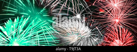Green white and red fireworks panoramic background Stock Photo
