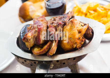 Popular Argentinian dish asado of grilled meats served at dinner Stock Photo