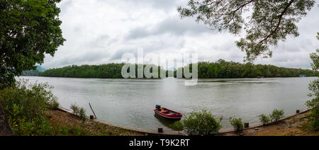 Scenic landscape of boat view in the big river and reservoir dam with mountain and nature forest