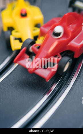 Toy cars colliding on a slot car race track Stock Photo
