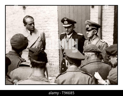 WW2 Doenitz Surrender Nazi Government Arrested 1945. Allied war correspondents interview, left to right: Albert Speer, Hitler’s Minister of Production; Grand Admiral Karl Donitz, Hitler’s successor, and Colonel General Gustav Jodl, acting Commander-in-Chief of the German Army, shortly after their arrest May 24, 1945, at Flonsburg, Germany. They were arrested by order of General of the Army Dwight D. Eisenhower, Supreme Allied Commander. Colonel General Hans-Goorg Friedeburg, who surrendered the German Navy to the Allies, was arrested at the same time but committed suicide. Stock Photo