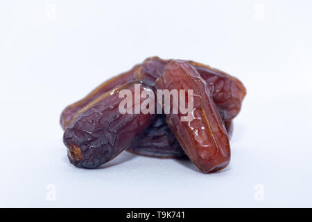 A group of medjool dates from Saudi Arabia on an isolated white background for Ramadan. Stock Photo