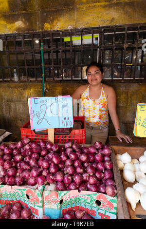 Mexican market - a young mexican woman selling onions at her stall, Merida food market, Merida Yucatan Mexico Latin America Stock Photo