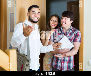 Realtor showing new flat to young family Stock Photo