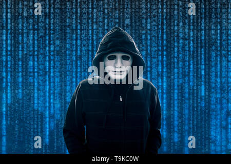 Hooded computer hacker with white mask Stock Photo