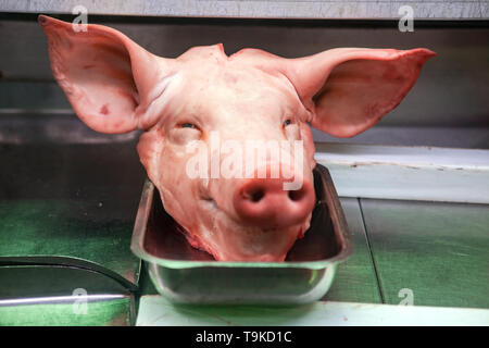The head of a pig lies in a butcher shop Stock Photo