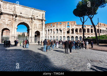 Rome, Italy - December 29, 2014: View of the Arch of Constantine and the Colosseum from Via dei Fori Imperiali, around some tourists and photographers Stock Photo