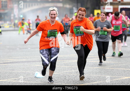 Competitors complete the Simply Health Manchester Run. Stock Photo