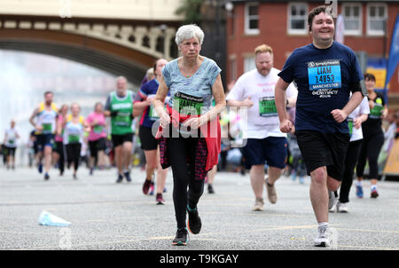 Competitors complete the Simply Health Manchester Run. Stock Photo